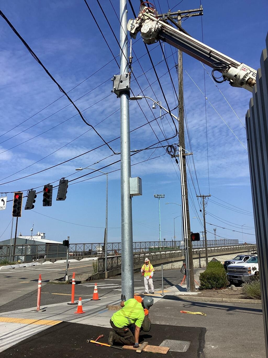 Crews installing a new signal pole at the intersection of Airport Way S and S Lucile St.