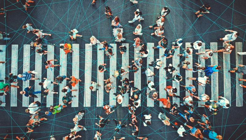 People walking across a busy crosswalk