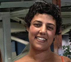 Zabia has short hair and smiles in the gallery.
