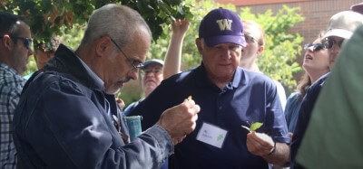 SPU's Clay Antieau identifies a leaf with several people watching.