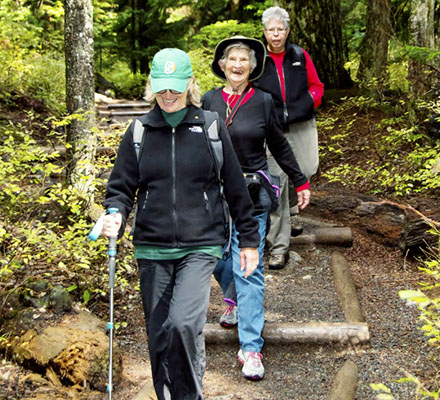 Senior citizens walk on a forest trail in Seattle