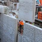 A crane and a worker installing Seawall Strata